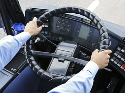 A driver at the wheel of a motorcoach